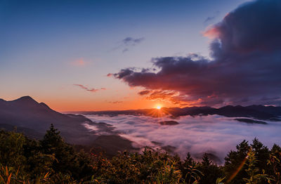 Scenic view of silhouette mountains against sky at sunset