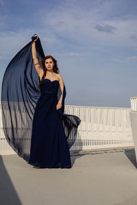 Portrait of woman standing against sky