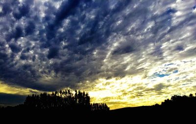 Silhouette of landscape against cloudy sky