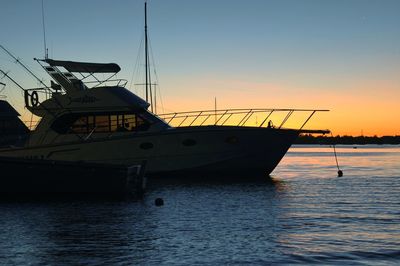 Ship sailing on sea against sky during sunset