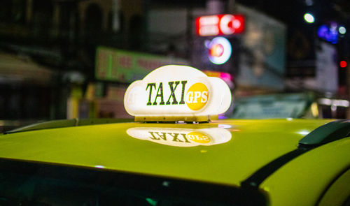Close-up of information sign on car at night