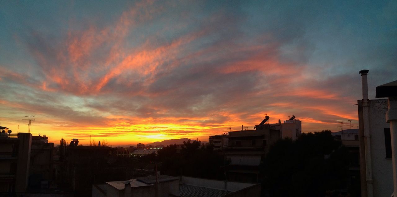 sunset, building exterior, orange color, architecture, built structure, sky, silhouette, cloud - sky, house, residential structure, residential building, beauty in nature, dramatic sky, cloud, city, scenics, nature, outdoors, building, cloudy