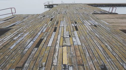 Tilt image of wooden post against sky