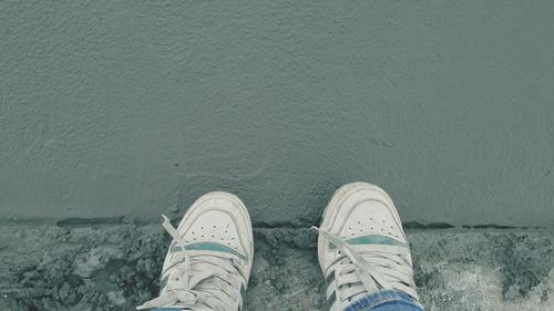 Low section of man standing on water