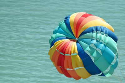 Colorful parachute over sea