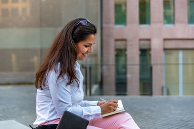 Young woman sitting outdoors