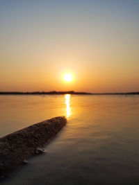 Scenic view of sea against clear sky during sunset