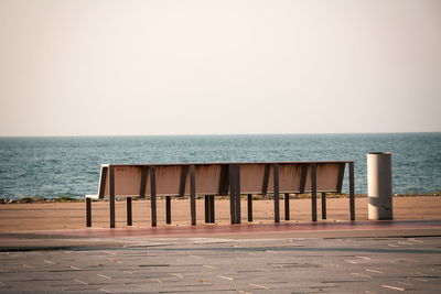 Lifeguard hut on beach against clear sky