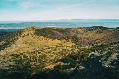 Scenic view of sea and mountains against sky