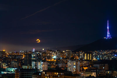 Illuminated buildings in city at night