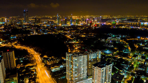 High angle view of city lit up at night