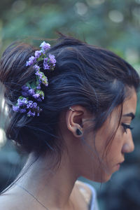 Close-up of woman with flowers in hair