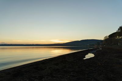 Scenic view of sea against clear sky during sunset