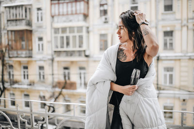 Full length of woman looking at city