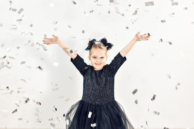 Portrait of happy girl with arms raised