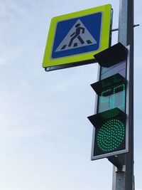 Low angle view of road sign against sky