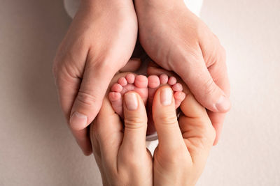 Cropped image of hand against wall