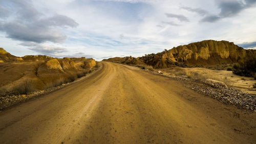 Dirt road passing through a desert