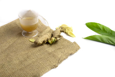 High angle view of drink on table against white background