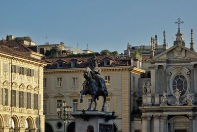 Statue of historic building against sky