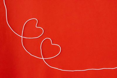 Close-up of heart shape against red background