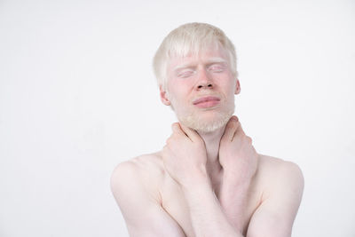 Portrait of shirtless man against white background