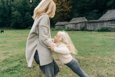 Rear view of woman standing on field