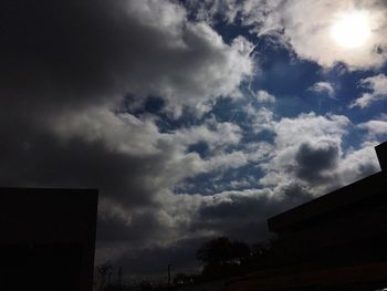 Low angle view of building against cloudy sky