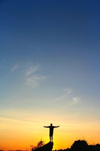 Low angle view of silhouette man against sky during sunset