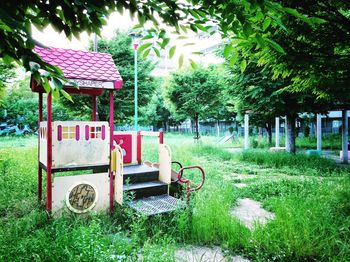 House by trees on field