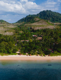 Scenic view of sea and mountains against sky