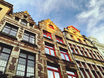 Low angle view of old building against cloudy sky