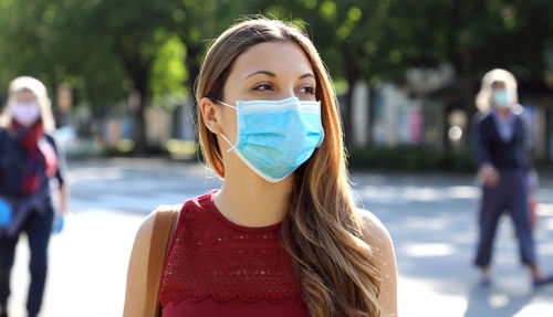 Close-up of woman wearing mask looking away