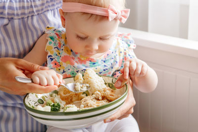 Midsection of woman holding food