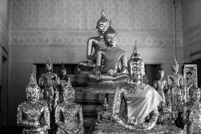 Statue of buddha against building