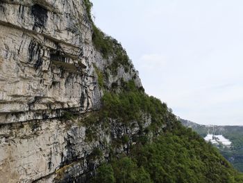 Low angle view of rocks on mountain against sky