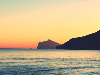 Scenic view of sea against orange sky