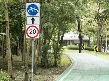 Road sign by trees