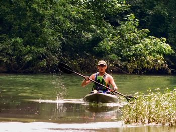 Teenage boy boating on river