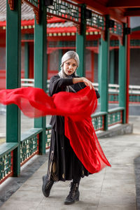 Low angle view of woman standing in city