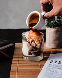 Midsection of person preparing food on table