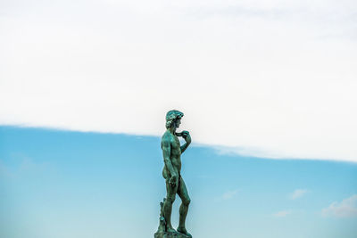 Low angle view of statue against sky