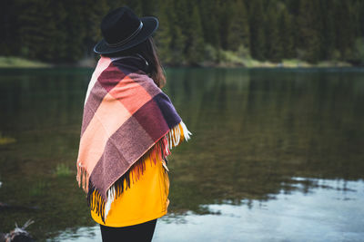 Side view of woman standing by lake