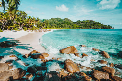 Scenic view of rocks in sea against sky