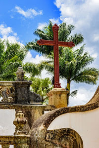 Low angle view of cross statue against sky