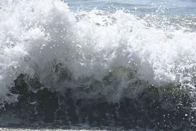 Close-up of water splashing against sky