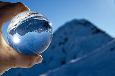 Close-up of hand holding crystal ball