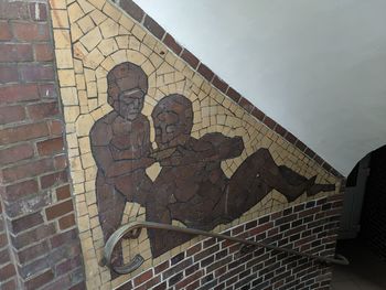 Low angle view of men on wall