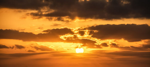 Scenic view of dramatic sky during sunset