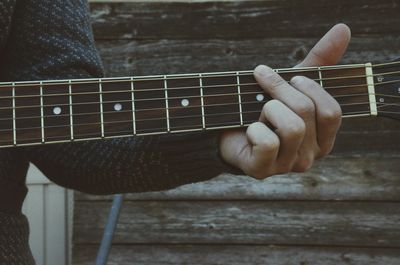 Cropped image of man playing guitar